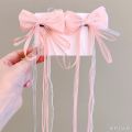 Bow ribbon tassel girl 2 piece hair clip set with bow decoration. 