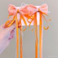 Bow ribbon tassel girl 2 piece hair clip set with bow decoration. 