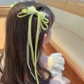 Bow ribbon tassel girl 2 piece hair clip set with bow decoration. 