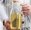 OIL JUG WITH WOODEN LID | AIR TIGHT WOODEN LID | 1000Ml , MEASURING OIL JUG | HIGH QUALITY BOROSILICATE MADE Glass | light in weight | can use in everyday kitchen utensils. 