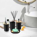 4-piece black bathroom accessories set, plastic toothbrush holder with bamboo cover, toothbrush cup, lotion dispenser, soap box. 