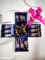 Chocolate Gift box with Cadbury dairy milk chocolates and Cadbury eclairs toffees automatic open with pink ribbon. 