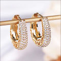 Huitan Hollow Gold Color Hoop Earrings for Women Paved Dazzling CZ Stone Luxury Trendy Female Circle Earrings Statement Jewelry.
