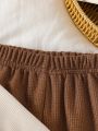 Baby girl two-piece autumn and winter printed round neck long sleeved ruffled T-shirt and elastic waisted brown bell bottom pant.