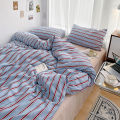 Simple Red and Blue Striped Duvet Cover and Four Piece Bed Sheet Set with Washed Cotton Bedding on the Bed. 