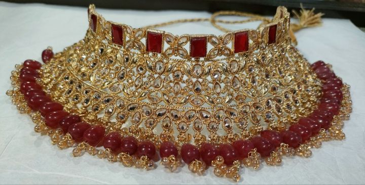 bridal first day jewellery heavy set in golden and red colour unique and stylish design