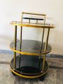 Tea Trolley circular shape golden color three shelf. 