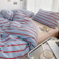 Simple Red and Blue Striped Duvet Cover and Four Piece Bed Sheet Set with Washed Cotton Bedding on the Bed. 