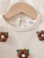 Baby girl two-piece autumn and winter printed round neck long sleeved ruffled T-shirt and elastic waisted brown bell bottom pant.