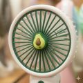 Mini Avocado Rechargeable Handheld Fan with Portable Base Stand.