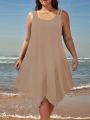 Large women's solid color asymmetrical hem camisole dress. 