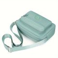 Lightweight Nylon Chic Crossbody Bag for Women - Adjustable Strap, Zip Closure, Tassel Accent, Solid Color.