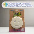 Free dual-sided scrubber + sponge (Scrub Daddy®) White smile face sponge. 