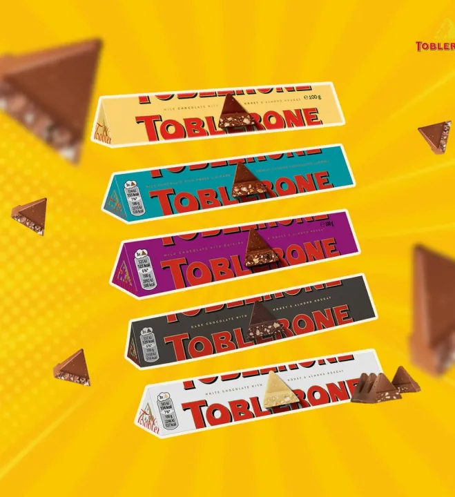 Toblerone%20Chocolate%20Bar,%20Enjoy%20Toblerone,%20The%20Iconic%20Triangular%20Chocolate%20from%20Switzerland%20(Pack%20of%204%20Milk,%20Dark,%20White,%20Fruit%20&%20Nut)%20-%20Image%203