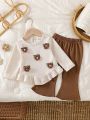 Baby girl two-piece autumn and winter printed round neck long sleeved ruffled T-shirt and elastic waisted brown bell bottom pant.