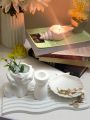 Set of 4 pc home decor set, one arch wavy tray, one shell tray, one candle holder, one lady head vase for flowers. 