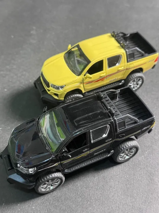 1:32%20Die%20Cast%20Toyota%20Hilux%20Pickup%20Model%20Toy%20%E2%80%93%20White%20%7C%20Pull%20Back,%20Opening%20Doors,%20Metal%20Bod%20-%20Image%204