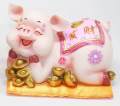 Lee Tai Fu pig lying on a golden nugget. 