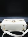 white coloured strap bag. 