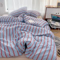 Simple Red and Blue Striped Duvet Cover and Four Piece Bed Sheet Set with Washed Cotton Bedding on the Bed. 