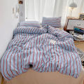 Simple Red and Blue Striped Duvet Cover and Four Piece Bed Sheet Set with Washed Cotton Bedding on the Bed. 