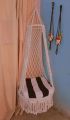 .macrame swing hanging chair in white color. 
