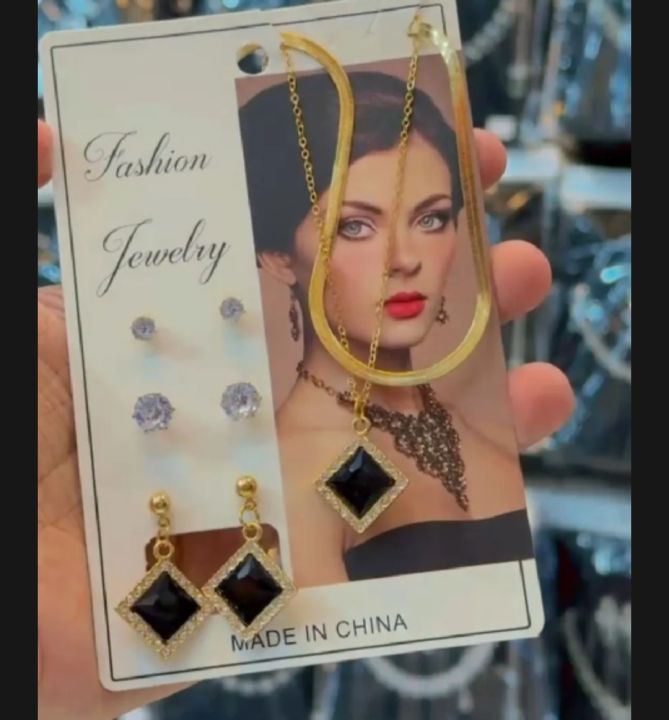 "Elegant fashion jewelry set with gold-tone chain, black stone pendant, and matching earrings — perfect for any occasion."