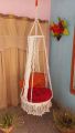 .macrame swing hanging chair in white color. 