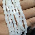 White doodiya matt  colour crystal string in kulfi shape size is 5/7 for sale in very reasonable price Price is 200 rupees per string Size is 5/7 Shape is kulfi. 