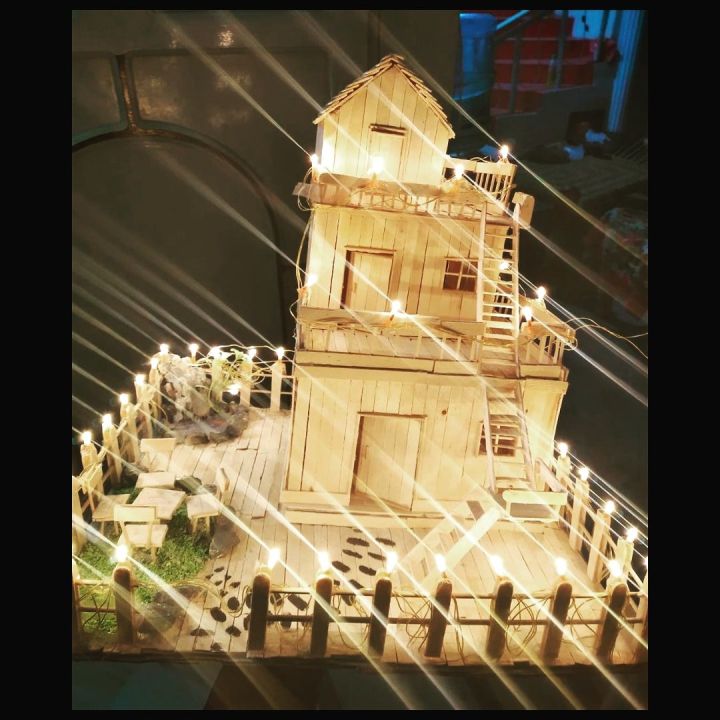 handmade ice cream stick house with fairy lights