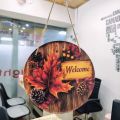 Fall Welcome Door Sign - 8 Inch Round Autumn Wood Grain Hanging Wall Decor with Maple Leaves, Pinecones & Berries. 