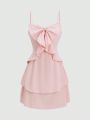 Fashionable women's waist cinched three-layer ruffle edge bow suspender dress. 