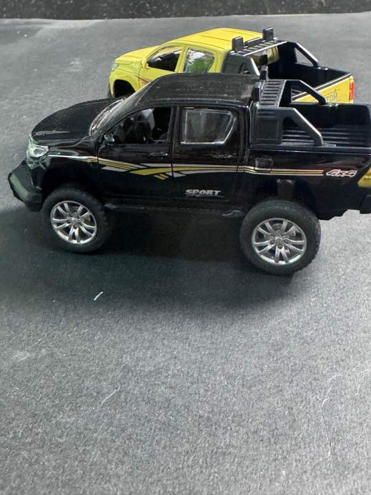 1:32%20Die%20Cast%20Toyota%20Hilux%20Pickup%20Model%20Toy%20%E2%80%93%20White%20%7C%20Pull%20Back,%20Opening%20Doors,%20Metal%20Bod%20-%20Image%206