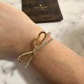 (C). Kate Spade Bow Bangle Bracelet. 