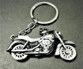 Metallic bike keychain with rotating wheels. 