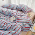 Simple Red and Blue Striped Duvet Cover and Four Piece Bed Sheet Set with Washed Cotton Bedding on the Bed. 