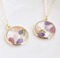 Custom (made to order) pressed flower resin necklaces. 