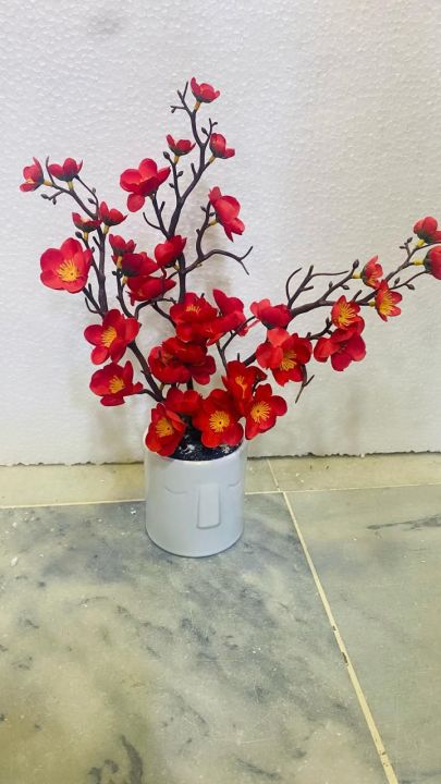 Artificial red flowers with pot