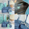 Cicelle shoulder bag oven modern denim fabric with Pearl knot pendant. 