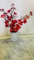 Artificial red flowers with pot. 