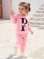 2-piece set of baby girl baby casual sports English letter printed hooded long sleeved hoodie hoodie and pants autumn and winter. 
