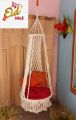 .macrame swing hanging chair in white color. 
