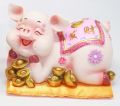 Lee Tai Fu pig lying on a golden nugget. 