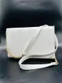 white coloured strap bag. 