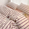 Simple Red and Blue Striped Duvet Cover and Four Piece Bed Sheet Set with Washed Cotton Bedding on the Bed. 