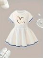 Summer girls' sporty style two-piece set with heart cartoon pattern print, pleated short skirt and short-sleeved T-shirt. 