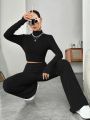 Stand Collar Navel T-shirt and Trumpet pants.