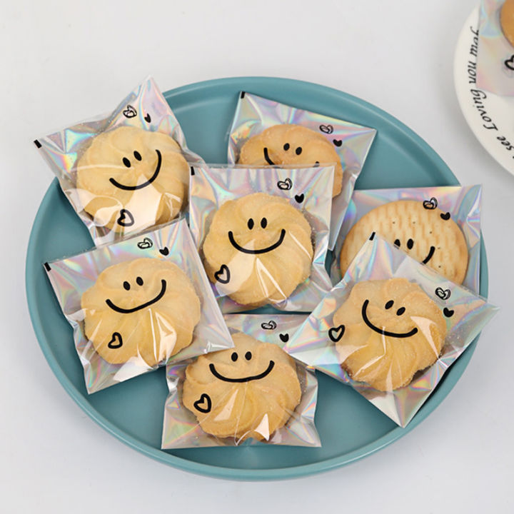 100pcs%20Cute%20Smiling%20Face%20Cookie%20Packaging%20Bag%20Laser%20Transparent%20Biscuit%20Bag%20Self-adhesive%20Bag%20Birthday%20Party%20Wedding%20Decoration%20-%20Image%205