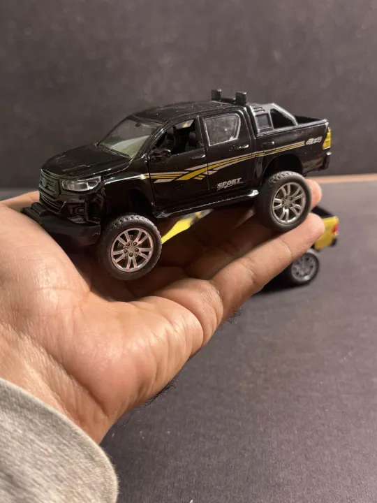 1:32%20Die%20Cast%20Toyota%20Hilux%20Pickup%20Model%20Toy%20%E2%80%93%20White%20%7C%20Pull%20Back,%20Opening%20Doors,%20Metal%20Bod%20-%20Image%205