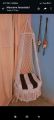 .macrame swing hanging chair in white color. 